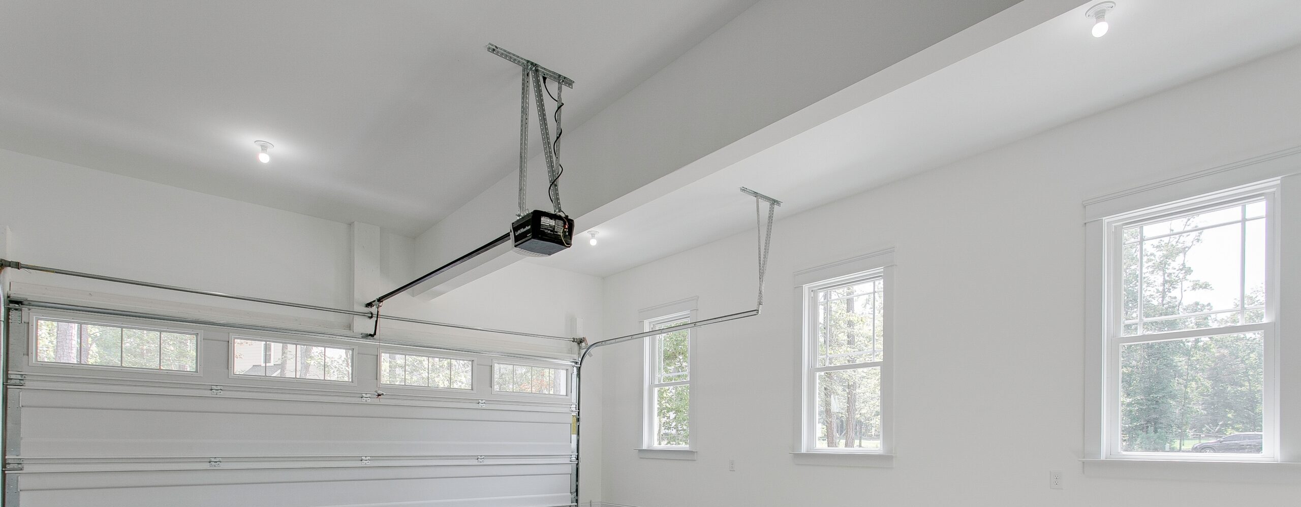 White garage with a garage door opener.