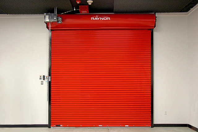 Red rolling steel fire-rated garage door installed in a commercial building for fire protection and code compliance.