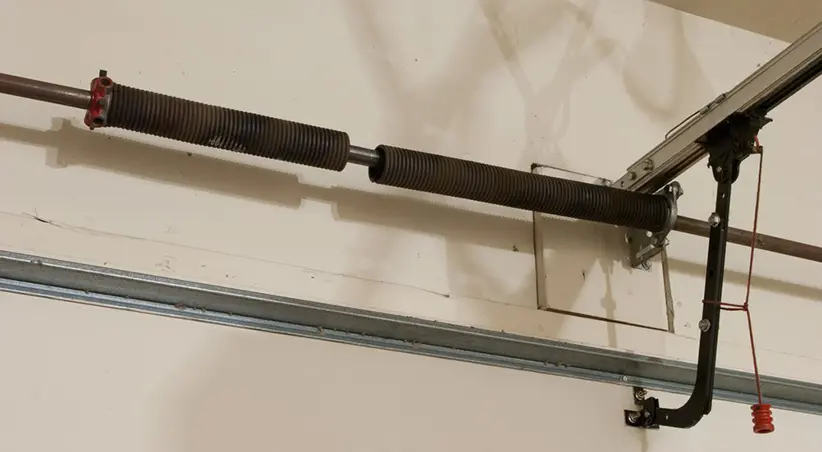 Broken garage door torsion spring with a visible gap, showing a common issue that requires professional garage door spring replacement.